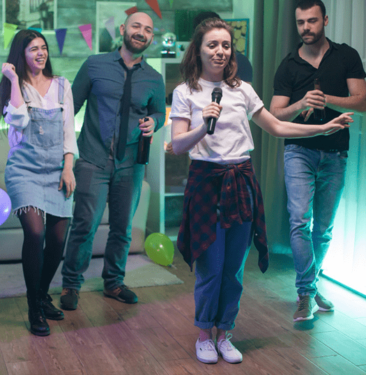 Friends singing and dancing at an indoor party