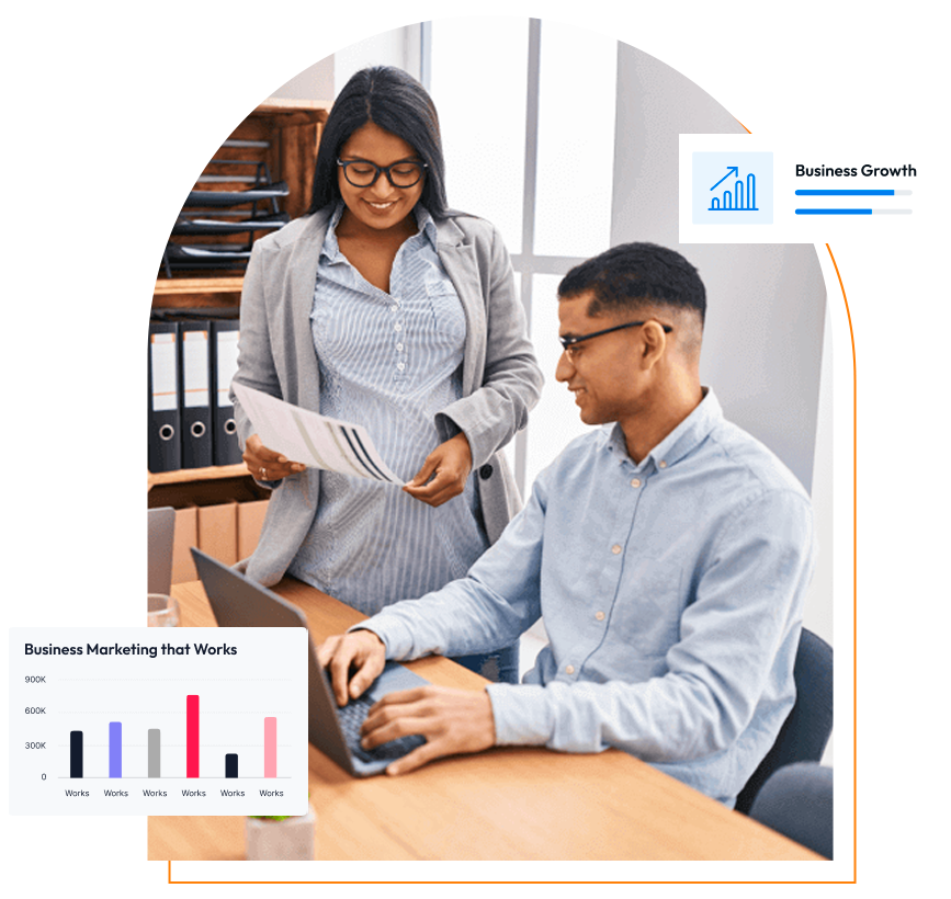 Two colleagues reviewing business performance on a laptop